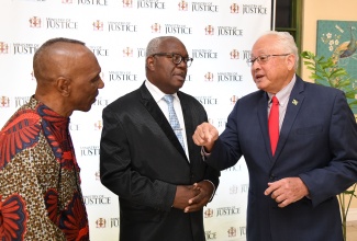 Minister of Justice, Hon. Delroy Chuck (right), converses with Bishop John Thorpe of Pentecostal Assemblies of the World, Jamaica Inc., (centre) and Pastor of Victory Churches International, Rev. Clinton Loney, during the 15th staging of the Restorative Justice Conference, held on Wednesday (February 7) at The Summit in Kingston.

