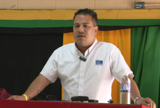 Minister without Portfolio in the Ministry of Economic Growth and Job Creation, Senator the Hon. Matthew Samuda, addresses the recent commissioning ceremony for the Cascade Phase Two Water Supply System Project in Hanover, which was held at Merlene Ottey High School in Pondside in the parish.

