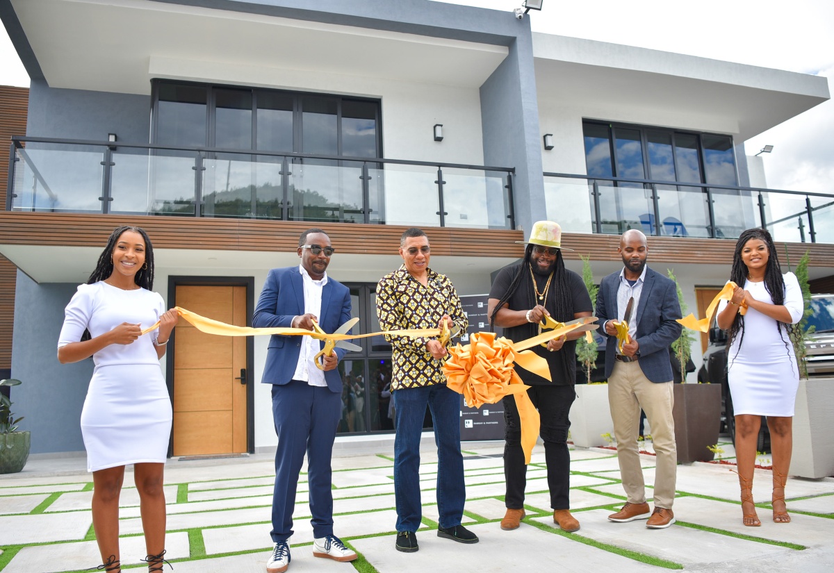 Prime Minister, the Most Hon. Andrew Holness (third left), cuts the ribbon symbolising the opening of the Sun Coast Beach Club in Twelve Miles, Bull Bay, on February 6. TCF Holdings CEO and Developer of the residential project, Kevin Frith (second left); Investor and entertainer, Gramps Morgan (third right); and TCF Holdings Limited Chairman, Lance Thomas (second right) are also a part of the momentous occasion.
