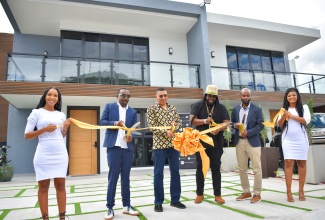 Prime Minister, the Most Hon. Andrew Holness (third left), cuts the ribbon symbolising the opening of the Sun Coast Beach Club in Twelve Miles, Bull Bay, on February 6. TCF Holdings CEO and Developer of the residential project, Kevin Frith (second left); Investor and entertainer, Gramps Morgan (third right); and TCF Holdings Limited Chairman, Lance Thomas (second right) are also a part of the momentous occasion.