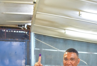 Prime Minister, the Most Hon. Andrew Holness, shows off his inked right index finger after casting his ballot in the 2024 Local Government elections at the Mona High School in Eastern St. Andrew on February 26.