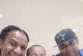Eight-year-old Dayton Jennings (centre), with mother, Simone Everett and father, Denzel Jennings, at the National Spelling Bee championship in Kingston on February 7.

