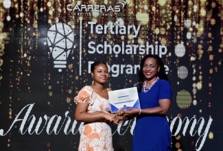Minister of State in the Ministry of Education and Youth, Hon. Marsha Smith (right), presents a Careeras Limited scholarship certificate of achievement to student, Khalilah Myers. The presentation was made during the company’s scholarship awards ceremony and brunch at the Jamaica Pegasus Hotel in New Kingston on Sunday (February 4).


