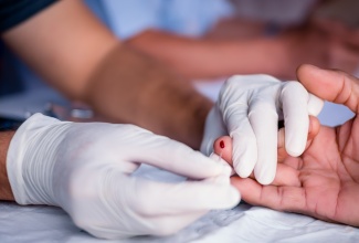 A health worker doing a finger prick test for HIV. 