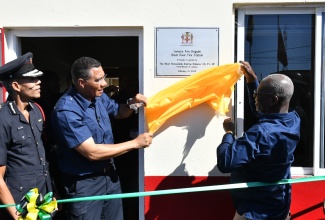 Prime Minister, the Most Hon. Andrew Holness ( centre), and Minister of Local Government and Community Development, Hon. Desmond McKenzie (right), unveil a plaque commemorating the official reopening of the renovated Black River Fire Station in St. Elizabeth, on Wednesday (February 21).  Looking on is Jamaica Fire Brigade (JFB) Commissioner, Stewart Beckford.