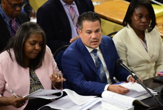 Minister without Portfolio in the Ministry of Economic Growth and Job Creation, Senator the Hon. Matthew Samuda (centre), responds to questions during today’s (March 6) sitting of the Standing Finance Committee of the House of Representatives. With the Minister are (from left) Chairperson for the Oversight Committee for the New Social Housing Programme, Judith Robb Walters, and Permanent Secretary in the Ministry, Arlene Williams.

