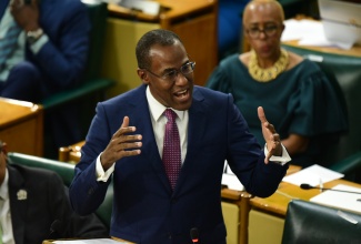 Minister of Finance and the Public Service, Dr. the Hon. Nigel Clarke, opens the 2024/25 Budget Debate in the House of Representatives on Tuesday, March 12. Listening keenly is Minister of Education and Youth, Hon. Fayval Williams.

