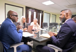 Minister of Labour and Social Security, Hon. Pearnel Charles Jr (left), is in discussion with Director, International Labour Organization (ILO) Decent Work Team and Office for the Caribbean, Joni Musabayana (right), during a courtesy call at the Ministry’s North Street offices on March 20. Others present (from second left) are Permanent Secretary in the Ministry, Colette Roberts Risden and Senior Advisor to the Minister, Bindley Sangster. The parties engaged in discussions to highlight the ILO's initiatives, strategies, and support mechanisms aimed at promoting decent work and social justice in Jamaica.
