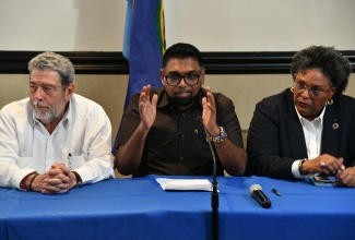 Caribbean Community (CARICOM) Chairman, and President of Guyana, Dr. Mohamed Irfaan Ali (centre), emphasises a point as he addresses a press conference held on Monday (March 11) at The Jamaica Pegasus hotel in New Kingston, following a CARICOM meeting on Haiti. He is flanked by Prime Minister of St. Vincent and the Grenadines, Dr.  Ralph Gonzalves (left) and Prime Minister of Barbados, Mia Mottley.

