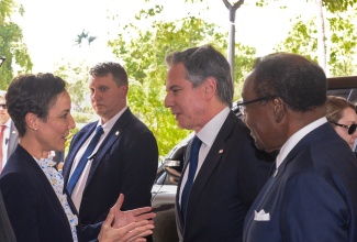Minister of Foreign Affairs and Foreign Trade, Senator the Hon. Kamina Johnson Smith (left), greets United States Secretary of State, Antony Blinken (second right), on his arrival at The Jamaica Pegasus hotel in New Kingston on Monday (March 11) for the high-level meeting on Haiti, being held under the aegis of the Conference of Heads of Government of the Caribbean Community (CARICOM). At right is United States Ambassador to Jamaica, His Excellency Nick Perry.

