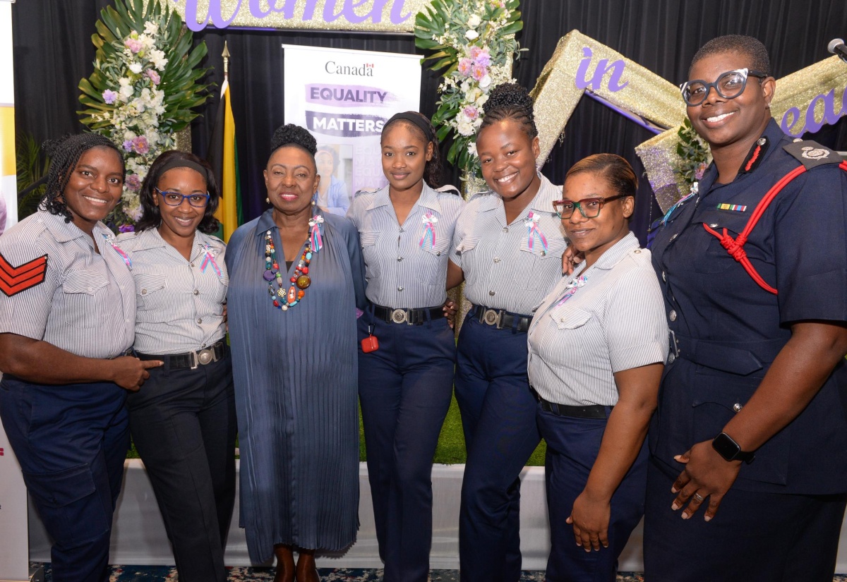 Minister of Culture, Gender, Entertainment and Sport, Hon. Olivia Grange, shares a photo opportunity with personnel from the Jamaica Fire Brigade during the International Women