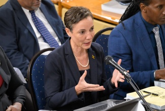 Minister of Foreign Affairs and Foreign Trade, Senator the Hon. Kamina Johnson Smith, speaks during the Standing Finance Committee of the House of Representatives meeting at Gordon House on Wednesday (March 6). At right is State Minister, Hon. Alando Terrelonge.