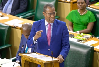 Minister of Finance and the Public Service, Dr. the Hon. Nigel Clarke, holds up a red card while closing the 2024/25 Budget Debate in the House of Representatives, on March 26.

