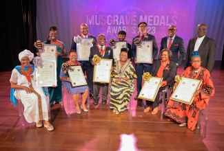 Minister of Culture, Gender, Entertainment and Sport, Hon. Olivia Grange (seated centre), joins the Musgrave Medal Award recipients onstage at the ceremony held on Wednesday (March 27), at the Philip Sherlock Centre for the Creative Arts, University of the West Indies (UWI) Mona, St. Andrew.