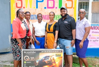Dermaine Sinclair of Cecil Auto Services Limited, hands over a television set to staff of the Chantilly Primary and Infant School (from left), Jayann Lee, Zasanya Rowe, Juleen Morrison, and Principal, Nicole Poyser. The television was among technology devices and school supplies donated by the business to the Westmoreland-based institution recently.