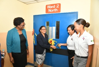 Chief Medical Officer, Dr. Jacquiline Bisasor-McKenzie (second left) cuts the ribbon to officially open the newly renovated Ward 2 North at the Kingston Public Hospital (KPH) to Tuesday (March 26). Looking on (from left) are Acting Chief Executive Officer at KPH, Dr. Natalie Whylie; Chief Executive Officer (CEO), D.M. Equipment Company Limited/Zoukie Trucking Services Limited, Michelle Henry; and Project Manager at the company, Joshelle Campbell.

