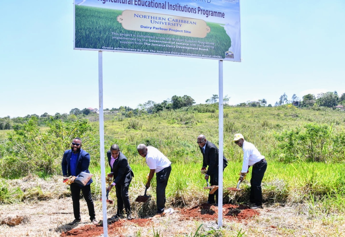Minister of Agriculture, Fisheries and Mining, Hon. Floyd Green (second left); State Minister in the Ministry, Hon. Franklin Witter (third left) along with (from left) Chief Executive Officer, Jamaica Dairy Development Board (JDDB) Devon Sayers; and President of Northern Caribbean University, Dr. Lincoln Edwards, break ground for the construction of a new milking parlor at Northern Caribbean University on Thursday (March 28).