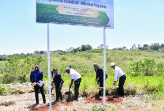 Minister of Agriculture, Fisheries and Mining, Hon. Floyd Green (second left); State Minister in the Ministry, Hon. Franklin Witter (third left) along with (from left) Chief Executive Officer, Jamaica Dairy Development Board (JDDB) Devon Sayers; and President of Northern Caribbean University, Dr. Lincoln Edwards, break ground for the construction of a new milking parlor at Northern Caribbean University on Thursday (March 28).