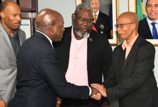 Minister of Labour and Social Security, Hon. Pearnel Charles Jr. (second left), greets President of the Caribbean Congress of Labour, André Lewis (right), during a courtesy call at the Ministry’s North Street offices in Kingston on Wednesday (March 6). Others (from left) are President, Jamaica Confederation of Trade Unions (JCTU), St. Patrice Ennis and Vice President, Bustamante Industrial Trade Union (BITU), Rudolph Thomas.

