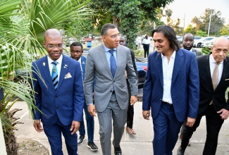 Prime Minister, the Most Hon. Andrew Holness (second left), in dialogue with Founder and Chief Executive Officer, Amber Group, Ambassador Dushyant Savadia, on arrival for the launch of the Amber UTech Launchpad at the University of Technology (UTech) campus in Papine, St. Andrew, on March 6. Accompanying them are President of  UTech, Dr. Kevin Brown (left) and Pro Chancellor of UTech, Aldrick McNab (right).