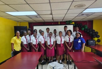Acting Director of Electronic Production at the Jamaica Information Service (JIS), Andrine Davidson (front row, left), shares a photo opportunity with sixth-form students at the Eltham High School in St. Catherine, following a tour of the Agency’s production departments on Thursday, March 14. They are joined by the school’s sixth-form coordinator, Tiffany Gordon (front row, right).

