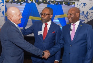 Minister of Industry, Investment and Commerce, Senator the Hon. Aubyn Hill (right), exchanges greetings with Head of Cooperation,  European Union (EU) Delegation to Jamaica, Aniceto Ruiz (left), while Judge of the Caribbean Court of Justice (CCJ), Hon. Justice Anderson, shares in the moment. Occasion was the CARIFORUM Intellectual Property Rights and Innovation Case law Conference for the CARIFORUM Region, Mercosur and Chile, held recently at the Spanish Court Hotel in Kingston.

