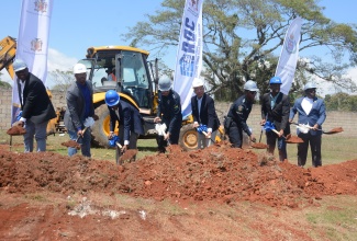 Deputy Prime Minister and Minister of National Security, Hon. Dr. Horace Chang (fourth right), is joined by (from left) Mayor of Savanna-la-Mar, Councillor Danree Delancy; Head of M&M Construction Limited, Richard Mullings; Chief Technical Director, Ministry of National Security, Delroy Simpson; Police Commissioner, Major General Antony Anderson; Deputy Commissioner, Dr. Kevin Blake; Member of Parliament, Westmoreland Central, George Wright; and Custos Rotulorum for Westmoreland, Canon Hartley Perrin, in breaking ground for the $2.7 billion Westmoreland Divisional Police Headquarters in Llandilo, Savanna-la-Mar, on Friday (March 15).