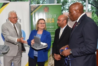 Minister of Justice, Hon. Delroy Chuck (left), joins High Commissioner for Canada to Jamaica, Her Excellency Emina Tudakovic; United Nations Development Programme (UNDP) Resident Representative, Kishan Khoday (second right); and Chief Justice, Hon. Bryan Sykes, at a ceremony for the handover of stenography machines and laptops to the justice system, held at the University of the West Indies (UWI) Regional Headquarters in Mona, St. Andrew on Friday (March 1). The items, valued at $30 million, were provided by the Government of Canada under the Social Justice Project (SO-JUST), which is being implemented by the UNDP.

