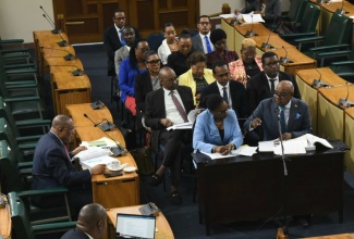 Minister of Tourism, Hon. Edmund Bartlett (right, front row), addresses members of the Standing Finance Committee of the House of Representatives at Gordon House on Tuesday (March 5). Accompanying him are Permanent Secretary in the Ministry, Jennifer Griffith (left, front row), and representatives of portfolio departments and agencies.

