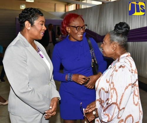 Minister of Culture, Gender, Entertainment and Sport, Hon. Olivia Grange (right) shares in conversation with (from left) Head of the Jamaica Constabulary Force (JCF) Corporate Communications Unit, Senior Superintendent of Police (SSP) Stephanie Lindsay, and Programme Officer at the Jamaica Social Investment Fund, Dawn Allison at the Jamaica Stock Exchange (JSE), International Women's Day Bell Ringing Ceremony, held on March 8 at the JSE Multipurpose Centre in Kingston.