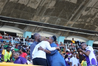 Minister of Culture, Gender, Entertainment and Sport, Hon. Olivia Grange (right), and Minister of Education and Youth, Hon. Fayval Williams, embrace in greeting on the final day of the ISSA/GraceKennedy Boys and Girls Championship 2024, at the National Stadium in Kingston on Saturday, March 23.