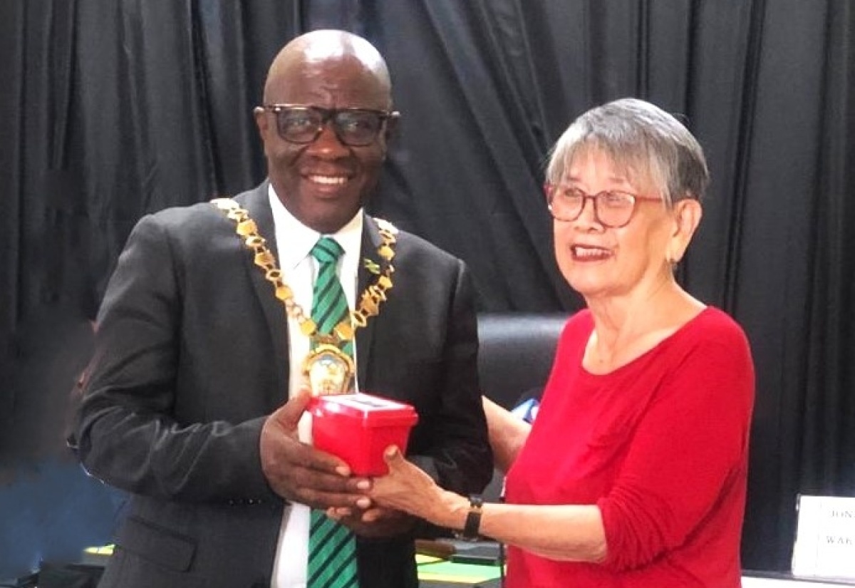 Chairman of the Trelawny Municipal Corporation (TMC) and Mayor of Falmouth, Councillor Collen Gager (left), receives an archival ‘Red Box’ from member of the Falmouth Chinese community, Joy Chin-See Livingstone, during a recent meeting of the Corporation in Falmouth.