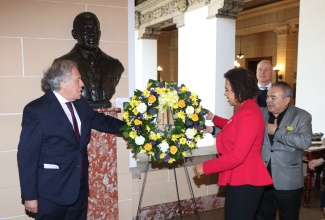 Jamaica’s Ambassador to the United States and Permanent Representative to the Organization of American States (OAS), Her Excellency Audrey Marks, places a floral tribute at the bust of Jamaica