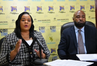 Chief Executive Officer of the Child Protection and Family Services Agency (CPFSA), Laurette Adams-Thomas (left), addresses a recent JIS Think Tank. Listening is the Director of Child and Family Services programme at the CPFSA, Dr. Warren Thompson.