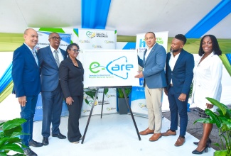 Minister of Health and Wellness, Dr. the Hon. Christopher Tufton (third right), launches the Electronic Health Records (EHR) System, at the May Pen Hospital, in Clarendon recently. Others pictured from left are Chairman of the Southern Regional Health Authority (SRHA), Wayne Chen; Parish Manager for Clarendon Health Services, Joseph Grant; Chief Executive Officer at the hospital, Eugena Clarke-James; Programme Manager for the Health Systems Strengthening Programme (HSSP), Orett Clarke; and Regional Technical Director at the SRHA, Dr. Vitillius Holder.