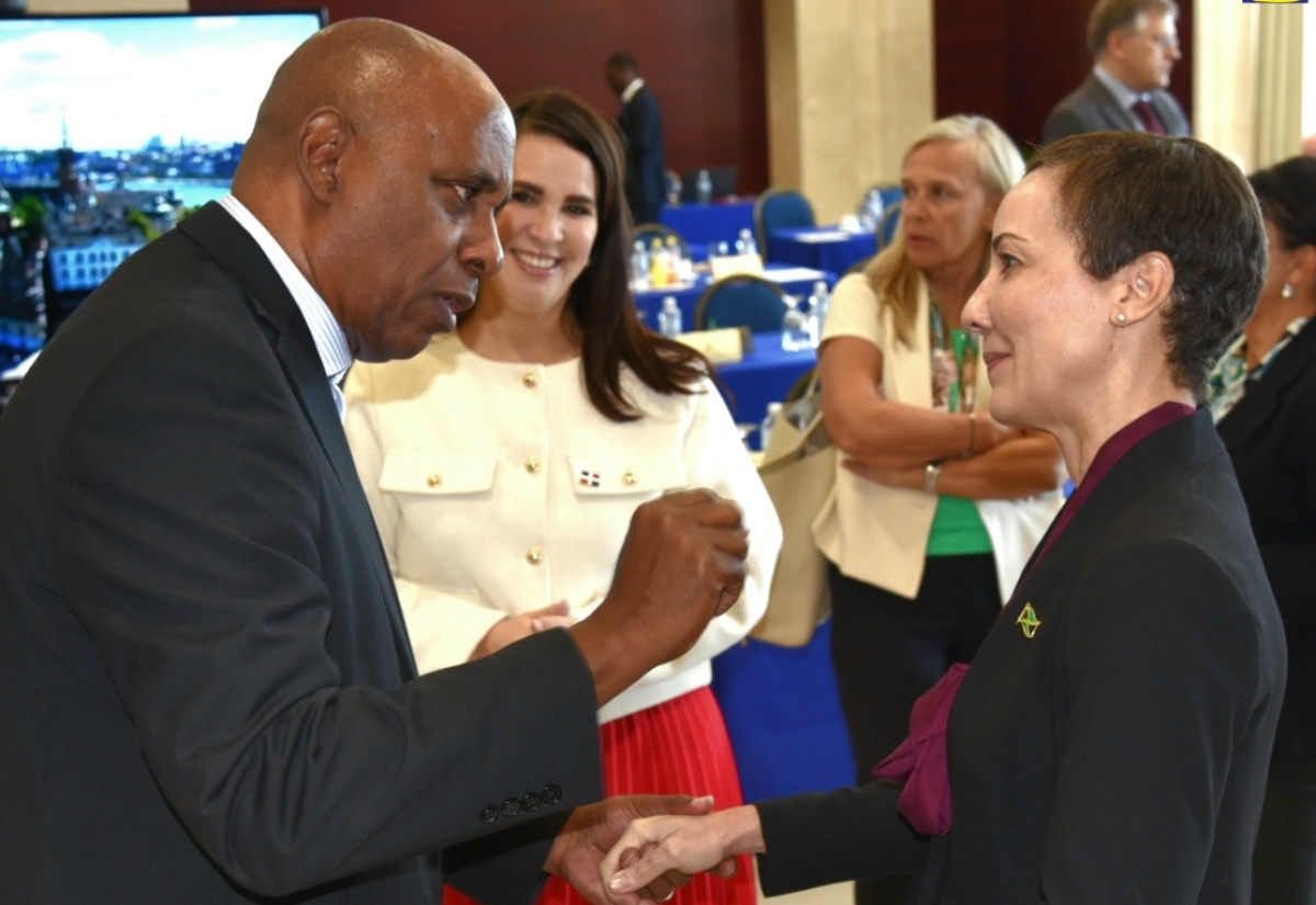 Minister of Foreign Affairs and Foreign Trade, Senator the Hon. Kamina Johnson Smith (right), converses with Dean of the Diplomatic Corps and Ambassador of the Republic of Panama to Jamaica, His Excellency Dr. Lasford Douglas, during a Diplomatic Days 2024 event at the Ministry in downtown Kingston on March 13. Listening is Ambassador of the Dominican Republic, Her Excellency Angie Shakira Martinez (second left).