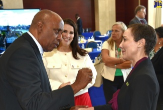 Minister of Foreign Affairs and Foreign Trade, Senator the Hon. Kamina Johnson Smith (right), converses with Dean of the Diplomatic Corps and Ambassador of the Republic of Panama to Jamaica, His Excellency Dr. Lasford Douglas, during a Diplomatic Days 2024 event at the Ministry in downtown Kingston on March 13. Listening is Ambassador of the Dominican Republic, Her Excellency Angie Shakira Martinez (second left).