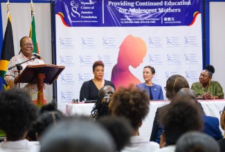  Minister of Culture, Gender, Entertainment and Sport, Hon. Olivia Grange (seated right); and Minister of Foreign Affairs and Foreign Trade, Senator the Hon. Kamina Johnson Smith, (seated second right), listen as South Africa’s Minister of International Relations and Cooperation, Her Excellency Dr. Grace Naledi Mandisa Pandor, addresses students and officials of the Women’s Centre of Jamaica Foundation (WCJF), during a visit to the Centre’s headquarters in Kingston on Thursday (March 21). Also at the head table is Chair, WCJF Board of Directors, Debby-Ann Brown Salmon.

