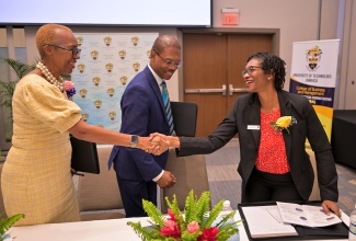Minister of Education and Youth, Hon. Fayval Williams (left), greets Head of the Association of Chartered Certified Accountants (ACCA) Caribbean, Paula Marcelle Irish. The event was the University of Technology (UTech) 15th Annual Students Accounting Seminar held on March 21 at the AC By Marriot Hotel in Kingston. President of Utech, Dr. Kevin Brown, is at centre.

