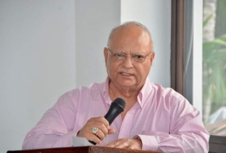 Owner of Gem Palace Duty Free Stores and St. Ann Businessman, Kumar Sujanani, announcing the donation of 25 new computers to the Ocho Rios Primary School at the Almond Tree Restaurant, Ocho Rios, St. Ann, on March 5.  

