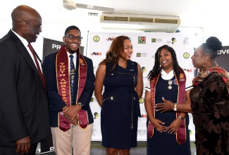 Minister of Culture, Gender, Entertainment and Sport, Hon. Olivia Grange (right), engages with the newly appointed Institute of Jamaica (IOJ) Youth Ambassadors, Cedar Grove Academy student, Kimya Anderson (second right) and Titchfield High student Raimi Richards (second left); during the launch of the programme on Wednesday (March 27) at the Ministry in Kingston. Sharing in the moment are Chair of the IOJ Council, Bishop Herro Blair; and President and Chief Executive Officer, Region 2, Proven Wealth, PROVEN Group Limited, Luwanna Williams.

