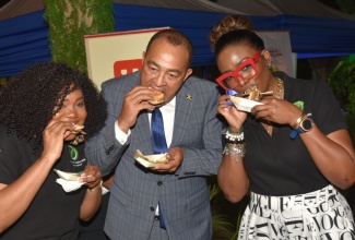 Minister of Health and Wellness, Dr. the Hon. Christopher Tufton (centre), along with ‘Better For You’ campaign ambassador, Kimberly Nain (left) and Director, Health Promotion and Protection, Dr. Simone Spence, has a taste of a vegan burger at the ‘Better For You’ campaign media relaunch event held at The Jamaica Pegasus hotel in New Kingston on March 21.

