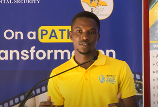 Programme of Advancement Through Health and Education (PATH) beneficiary, Zackarie Campbell, speaks about the benefits of the programme, at the ‘On the PATH to Transformation’ town hall meeting in Portmore, St. Catherine, on March 27.