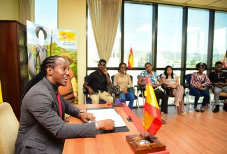State Minister for Foreign Affairs and Foreign Trade, Hon. Alando Terrelonge, speaks to students from the University of the West Indies (UWI) Mona Spanish Programme during a World Book Day event held on Tuesday (April 23) at the Embassy of Spain in New Kingston.