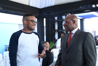 Minister of Industry, Investment and Commerce, Senator the Hon. Aubyn Hill (right), shares in conversation with Chief Executive Officer, Neish Creative Group Limited, Jason McNeish. Occasion was the grand opening of the Neish Creative Factory on Thursday (April 11) at Garmex Free Zone Factory in Kingston. The 6,000-square-foot mini warehouse complex will serve as the official office space of the Neish Creative Group. It includes four studio spaces for creatives and content creators to produce digital work.