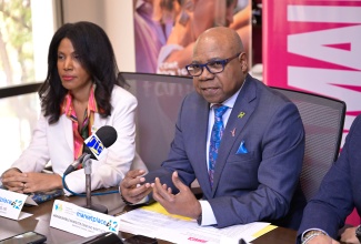 Minister of Tourism, Hon. Edmund Bartlett, addresses a recent press briefing at the Jamaica Tourist Board (JTB), in New Kingston. With the Minister is  President, Caribbean Hotel and Tourism Association (CHTA), Nicola Madden-Greig.

