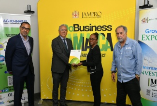 Chief Executive Officer (CEO), Agro-Investment Corporation (Agro-Invest), Vivion Scully (second left); and President, Jamaica Promotions (JAMPRO), Shullette Cox (second right), display the signed Memorandum of Understanding (MOU), which will strengthen collaboration between the entities to promote growth in investment and export of agribusiness products. Sharing the moment are Chairman of the Board of Directors, Agro-Invest, Ian Murray (left), and Deputy Chairman, JAMPRO, Ian Levy. The signing ceremony was held on April 4 at JAMPRO’s corporate offices in Kingston.
