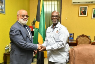 Minister of Local Government and Community Development, Hon. Desmond McKenzie (right), greets General Manager, Caribbean Country Department and Country Representative, Jamaica, Inter-American Development Bank (IDB), Anton Edmunds, during a courtesy call at the Ministry's Hagley Park Road offices in St. Andrew on April 5.


