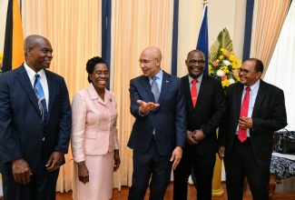 Governor-General, His Excellency the Most Hon. Sir Patrick Allen (centre), interacts with members of the Jamaica Umbrella Groups of Churches during their courtesy call at King’s House on Tuesday (April 16). From left are Bishop Alvin Bailey; Chair, Reverend Dr. Elaine McCarthy; Reverend Courtney Gordon, and Reverend Peter Garth.

