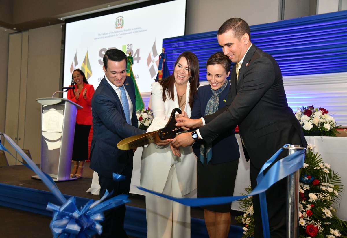 Minister of Foreign Affairs and Foreign Trade, Senator the Hon. Kamina Johnson Smith (second right), along with (from left) President, Jamaica Chamber of Commerce in the Dominican Republic, Juan José Melo; Ambassador of the Dominican Republic to Jamaica, Her Excellency Angie Martinez; and Vice Minister of Bilateral Foreign Policy in the Ministry of Foreign Affairs in the Dominican Republic, José Julio Gómez, cuts the ribbon to officially open the second Dominican Republic-Jamaica Business Forum at the AC Hotel by Marriott Kingston on Wednesday (April 18).

